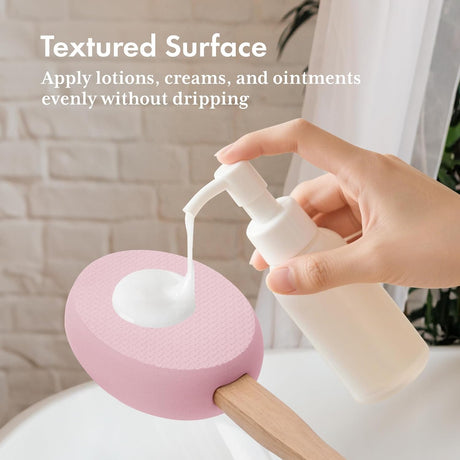 Lotion dispensed onto the textured pink EVA pad of the AmazerBath back applicator.