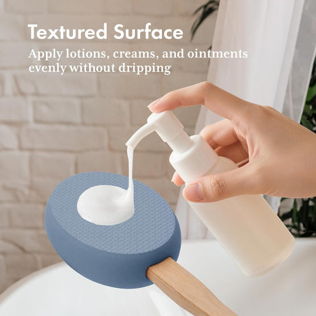 Lotion dispensed onto the textured slate blue EVA pad of the AmazerBath back applicator.