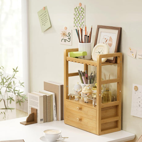 AmazerBath bamboo countertop vanity organizer with two drawers, open shelves and side rails on a desk.