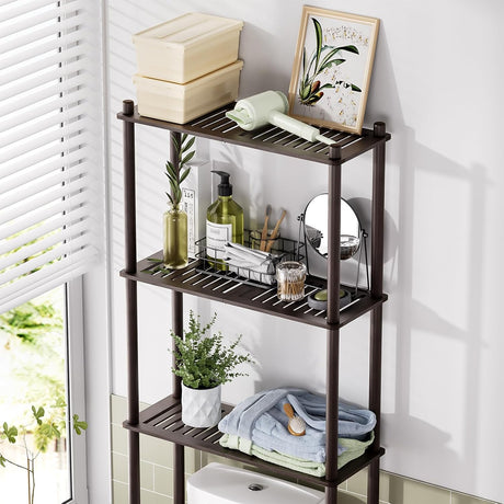 AmazerBath espresso bamboo over-the-toilet storage shelf organized with towels, toiletries, and decor.