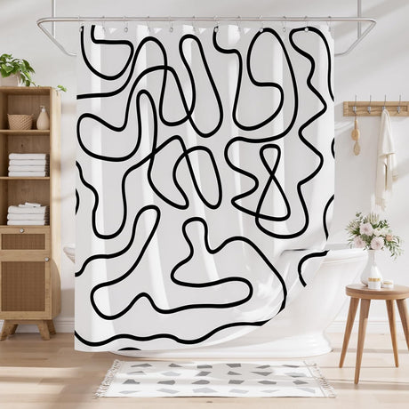 Black abstract AmazerBath shower curtain installed in a modern white bathroom.