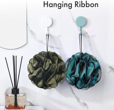AmazerBath grey charcoal loofah sponges hanging from their attached ribbons on bathroom wall hooks.