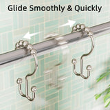 Nickel metal double shower curtain hooks with roller balls gliding smoothly along a bathroom shower rod.