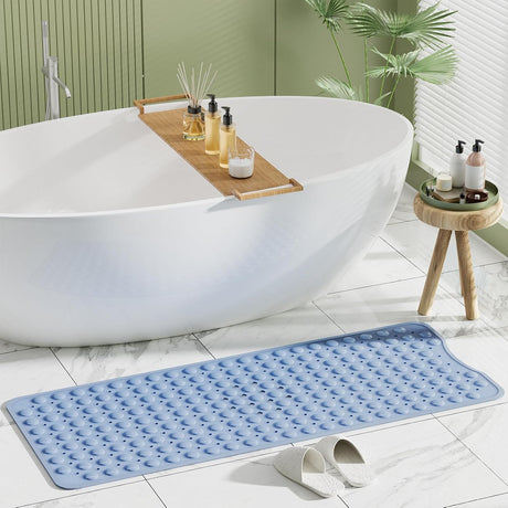 Blue AmazerBath non-slip bathtub mat placed beside a freestanding tub in a modern bathroom.