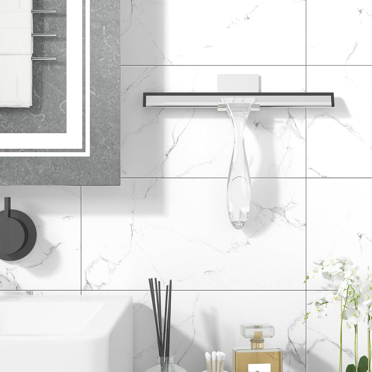 AmazerBath clear shower squeegee hanging from its adhesive wall hook beside a shower.