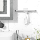 AmazerBath clear shower squeegee hanging from its adhesive wall hook beside a shower.