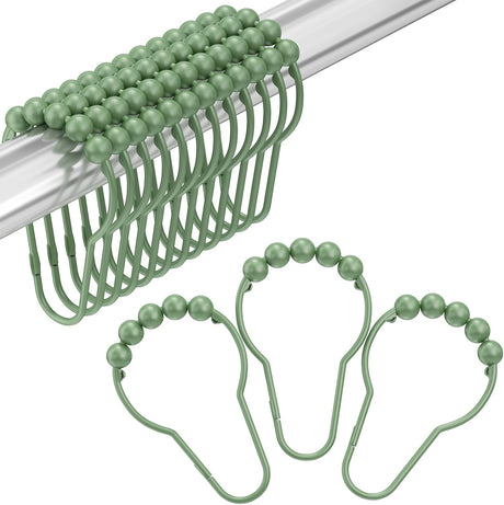 Green beaded shower curtain hooks on a white background