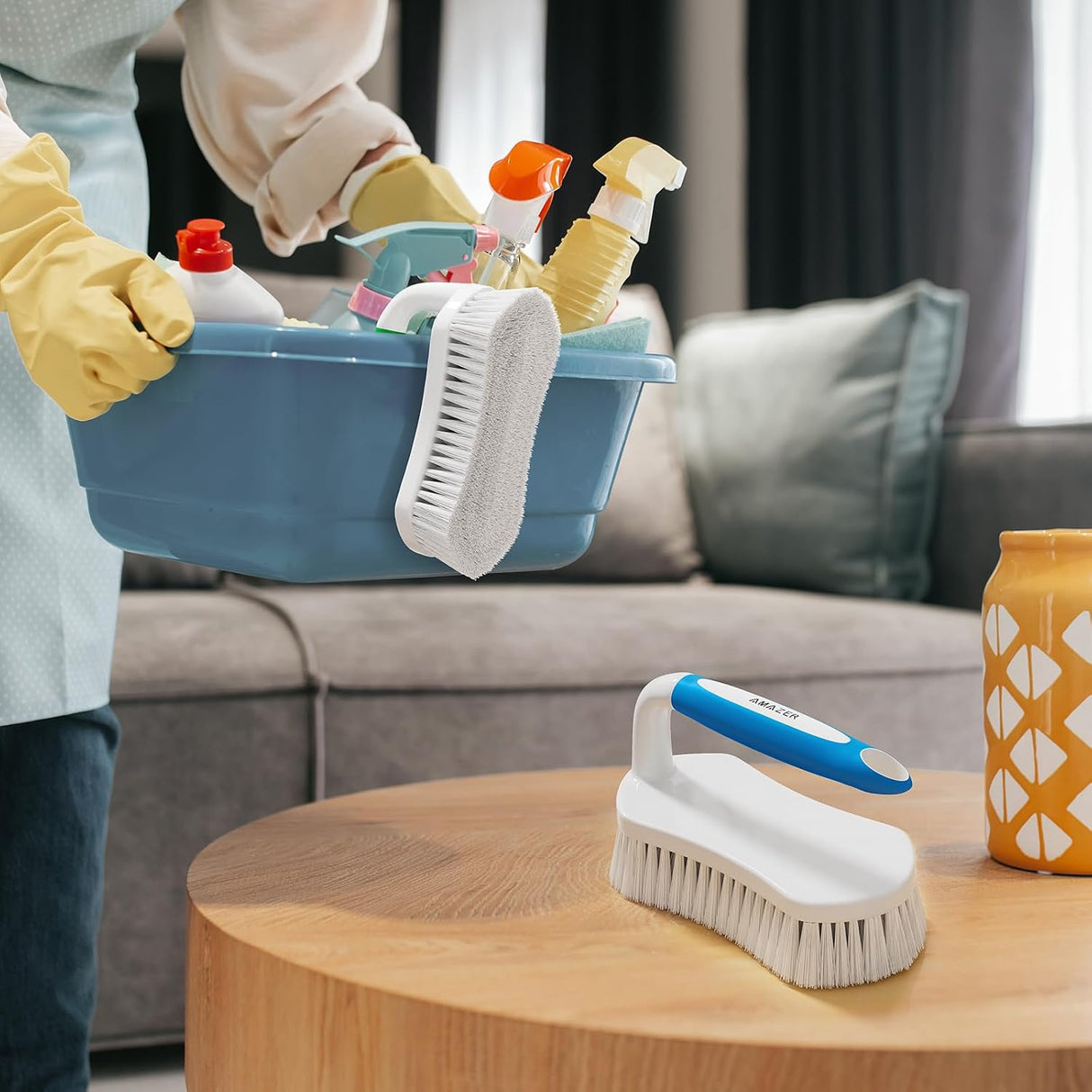 AmazerBath blue and green stiff-bristle scrub brush pair arranged with household cleaning supplies.