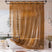 Amber translucent AmazerBath Sun EVA shower curtain liner installed around a white bathtub.
