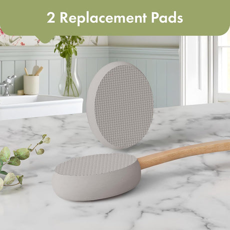 AmazerBath Grey back lotion applicator with two oval replacement pads displayed on a bathroom countertop.