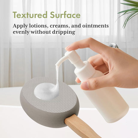 AmazerBath Grey back lotion applicator pad holding dispensed lotion on its textured surface without dripping.