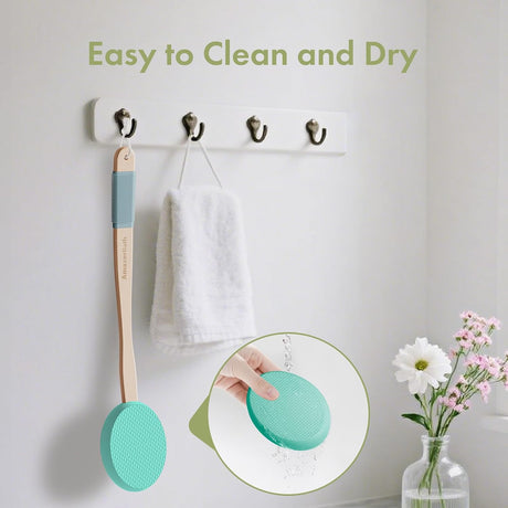 AmazerBath Lime back lotion applicator rinsed under water and hanging beside a towel to air-dry.