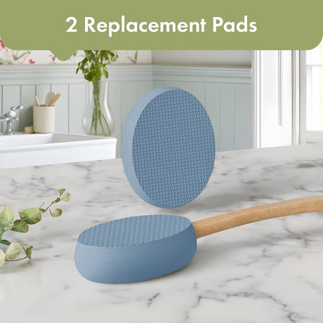 AmazerBath Slate Blue back lotion applicator with two oval replacement pads displayed on a bathroom countertop.