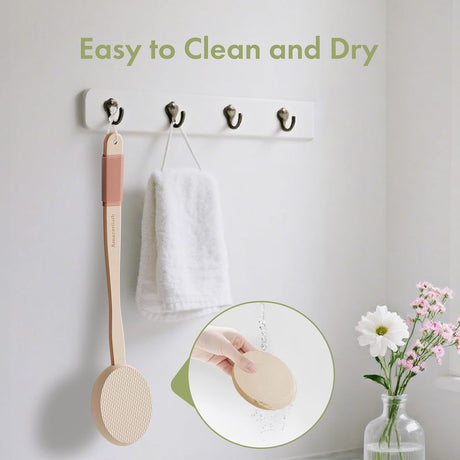 AmazerBath Soft Beige back lotion applicator rinsed under water and hanging beside a towel to air-dry.