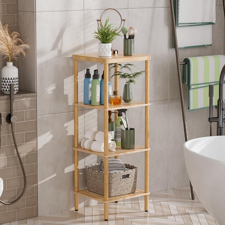 AmazerBath natural bamboo four-tier standing shelf holding bottles, towels, a basket, and plants beside a bathtub.