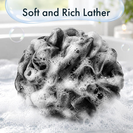 A Black bath sponge from the set of three creates rich foam in a hand, showing its soft mesh for everyday bathing.