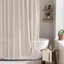 AmazerBath beige striped linen curtain: striped fabric and white tassel trim frame a bathtub in a bright bathroom.