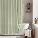 AmazerBath sage green striped linen curtain: striped fabric and white tassel trim frame a bathtub in a bright bathroom.