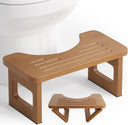 AmazerBath dark wood foldable toilet stool: the compact folding stool rests in front of a toilet with its support legs visible.