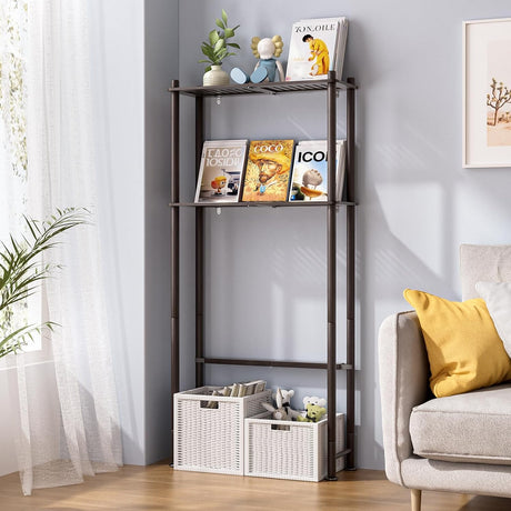 AmazerBath Espresso bamboo two-tier over-the-toilet shelf used beside a sofa for books, decor, and storage baskets.