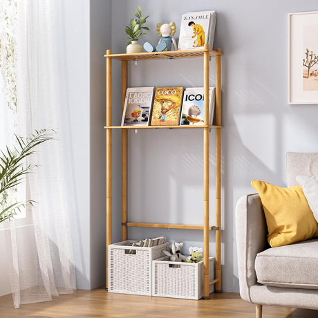 AmazerBath Natural bamboo two-tier over-the-toilet shelf used beside a sofa for books, decor, and storage baskets.