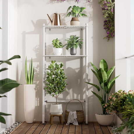 AmazerBath White bamboo two-tier over-the-toilet shelf used outdoors as a freestanding display for potted plants.