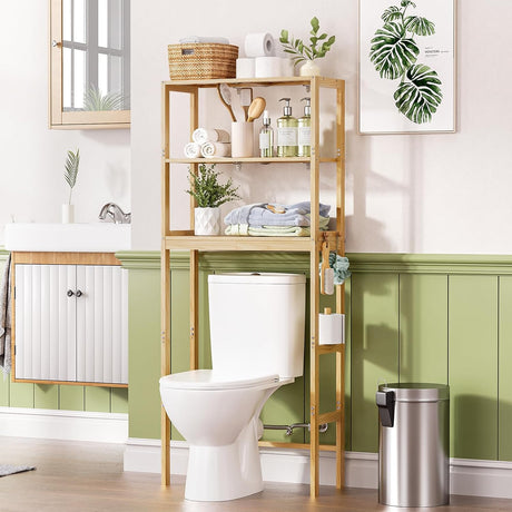 AmazerBath pine three-tier over toilet rack: the rack stands above a toilet with towels, baskets, and plants in a bright bathroom.