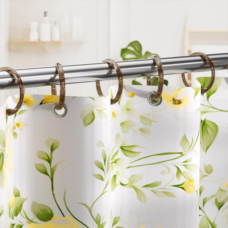 AmazerBath Amber Brown plastic shower curtain rings holding a floral shower curtain across a polished metal rod.
