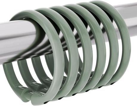 AmazerBath Sage Green plastic shower curtain rings grouped on a metal rod, showing the rounded profile and snap closures.