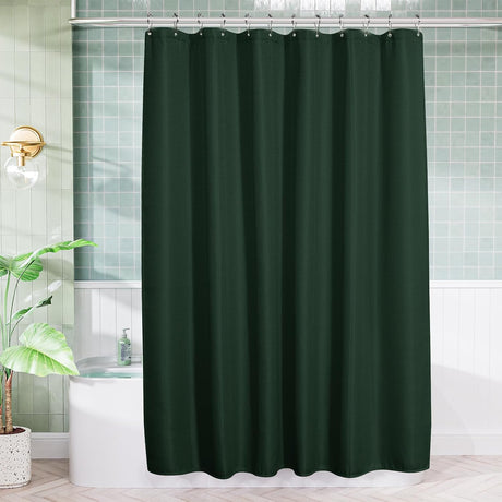 AmazerBath Dark Green waffle shower curtain hanging above a white bathtub in a bright bathroom with green wall tiles.