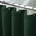 AmazerBath Dark Green waffle shower curtain with a folded top hem, textured fabric, metal grommets, and hooks on a rod.