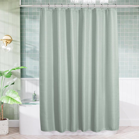 AmazerBath Grayish Green waffle shower curtain hanging above a white bathtub in a bright bathroom with green wall tiles.