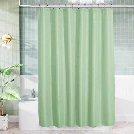AmazerBath Mint Green waffle shower curtain hanging above a white bathtub in a bright bathroom with green wall tiles.