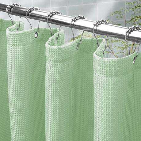 AmazerBath Mint Green waffle shower curtain with a folded top hem, textured fabric, metal grommets, and hooks on a rod.